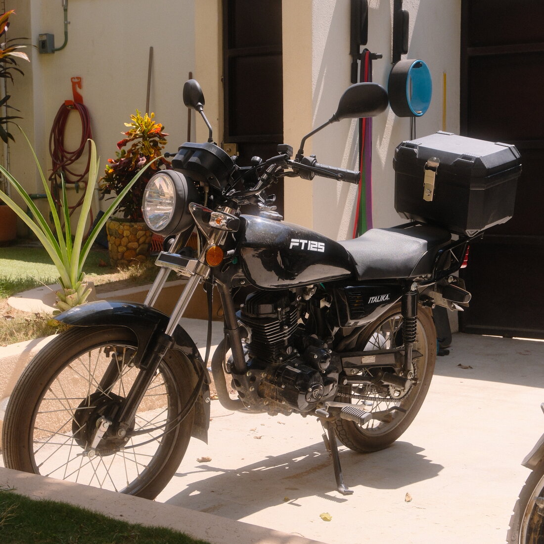 A rental moto parked in the courtyard