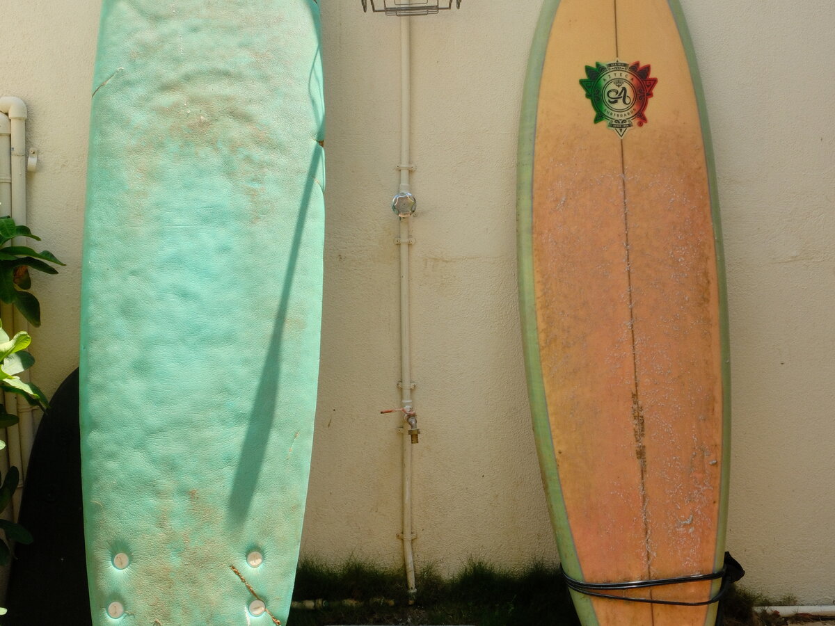 Two surfboards leaning against the wall, ready to borrow