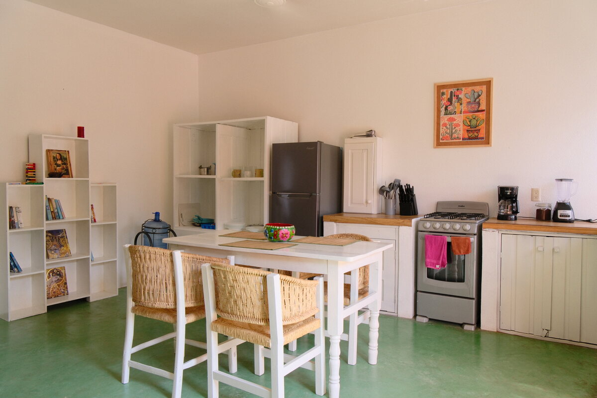 Casa Linda kitchen — full kitchen and dining table with woven chairs