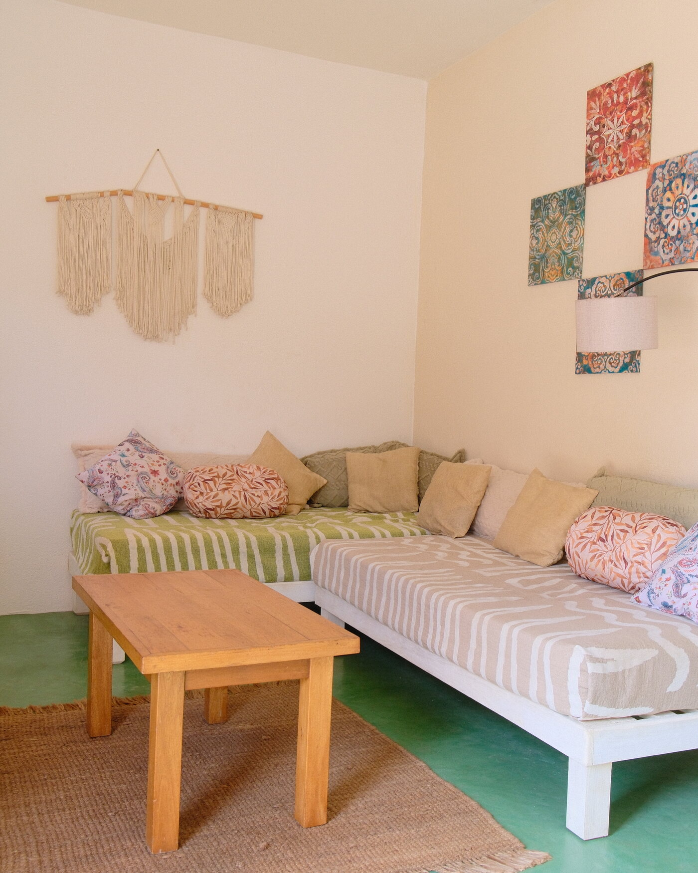 Casa Linda — second-floor living room with an L-shaped daybed, macramé, and warm light