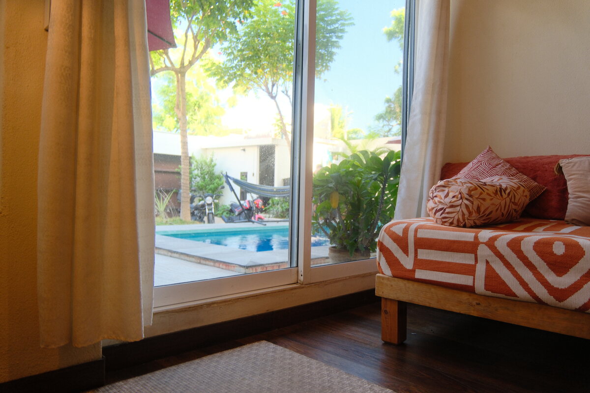 Casa Mia — cushioned daybed by the window with a view onto the pool