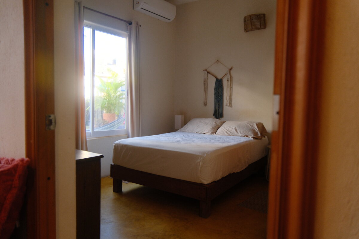 Casa Mia bedroom — bed beside a bright window