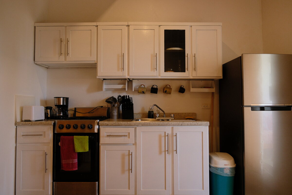 Casa Peach kitchen — gas range, coffee maker, and full-size fridge